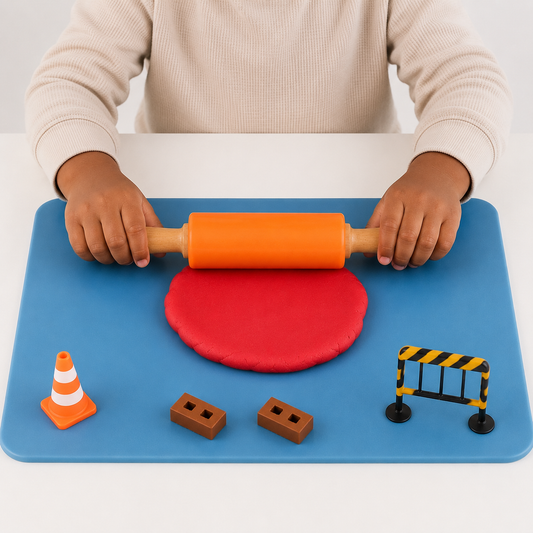 A child rolling red playdough flat with the orange silicone rolling pin